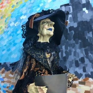 Lucretia LaBoo figurine holding book of spells.  21 and half inches tall.